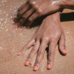 Self tanning lotion on hands at the beach